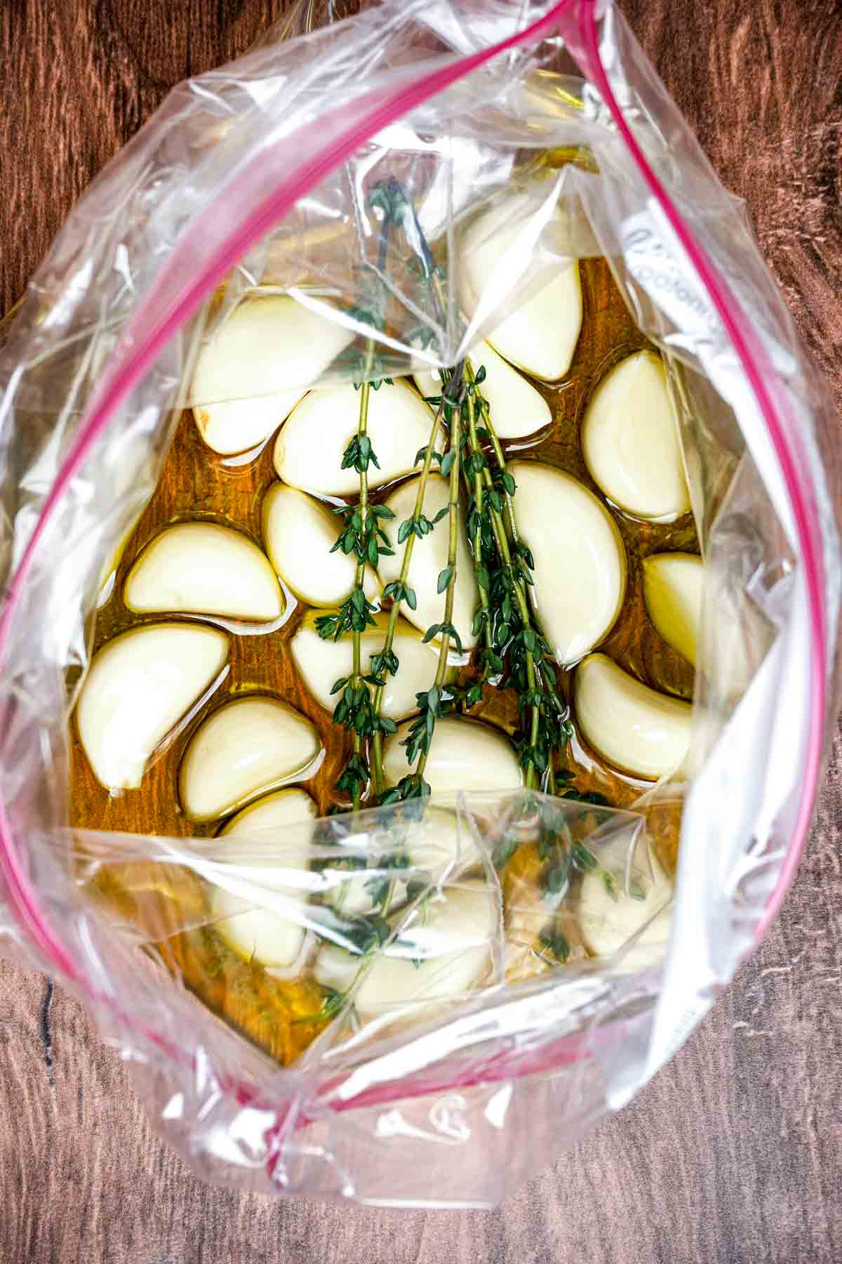 garlic cloves, thyme and oil in a plastic bag