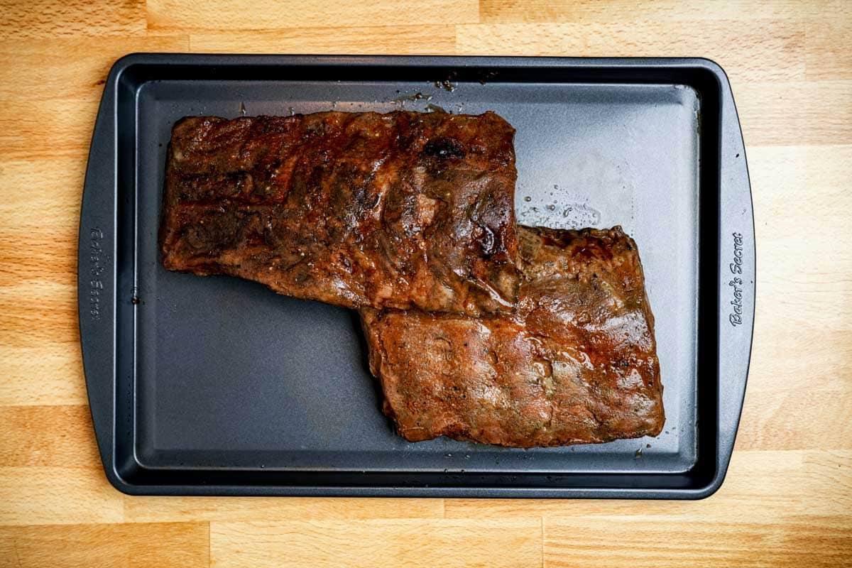 cooked ribs on a baking sheet