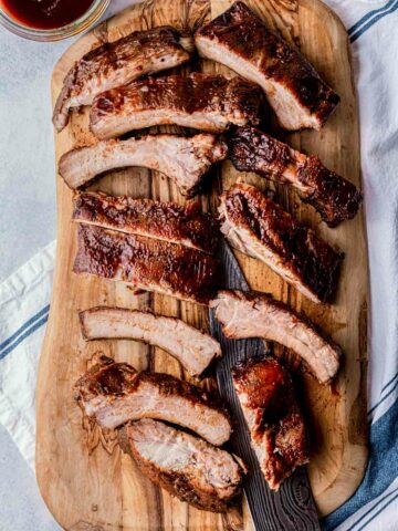 ribs on a cutting board with a knife