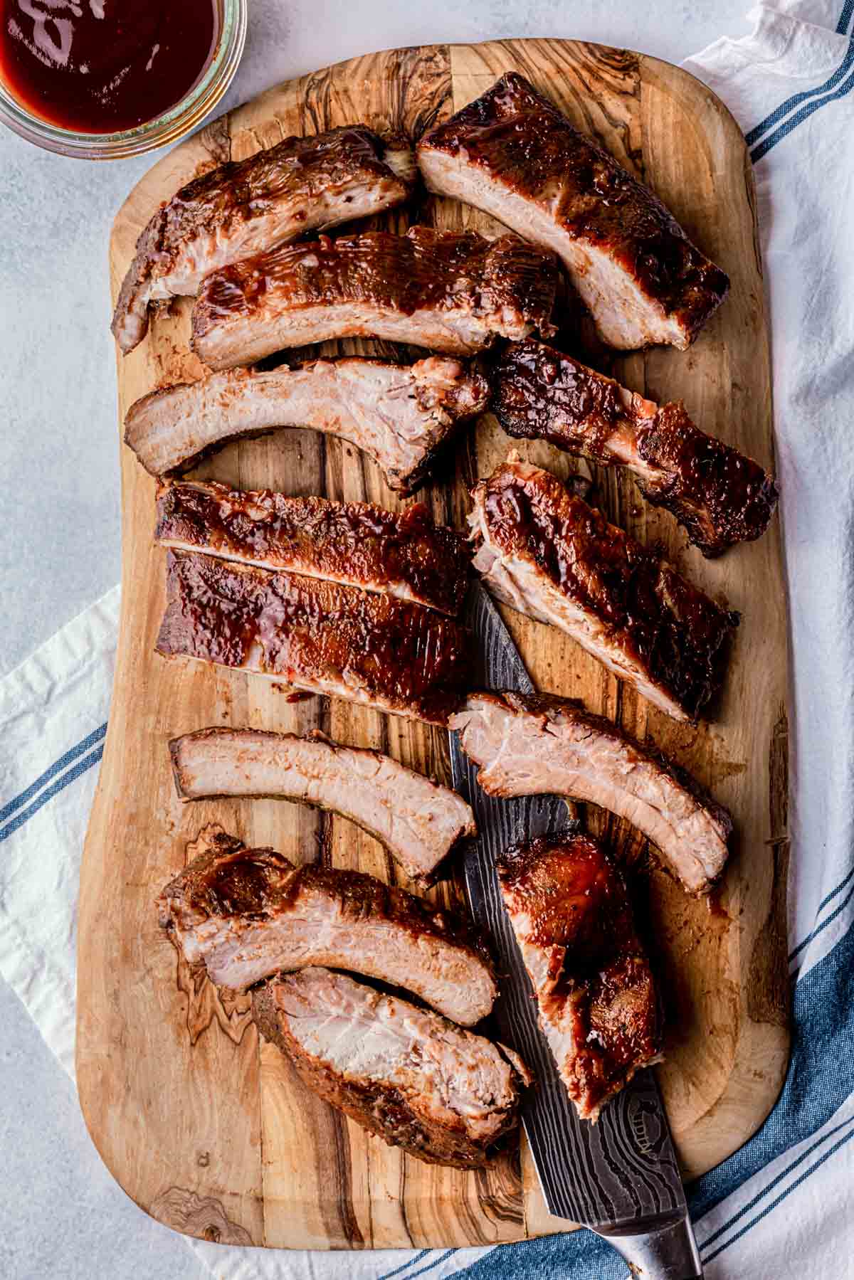 ribs on a cutting board with a knife