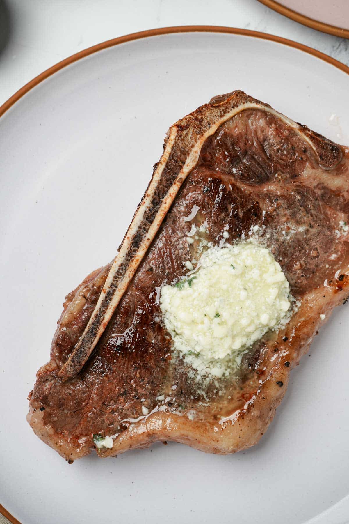close up of a steak with melted butter on top