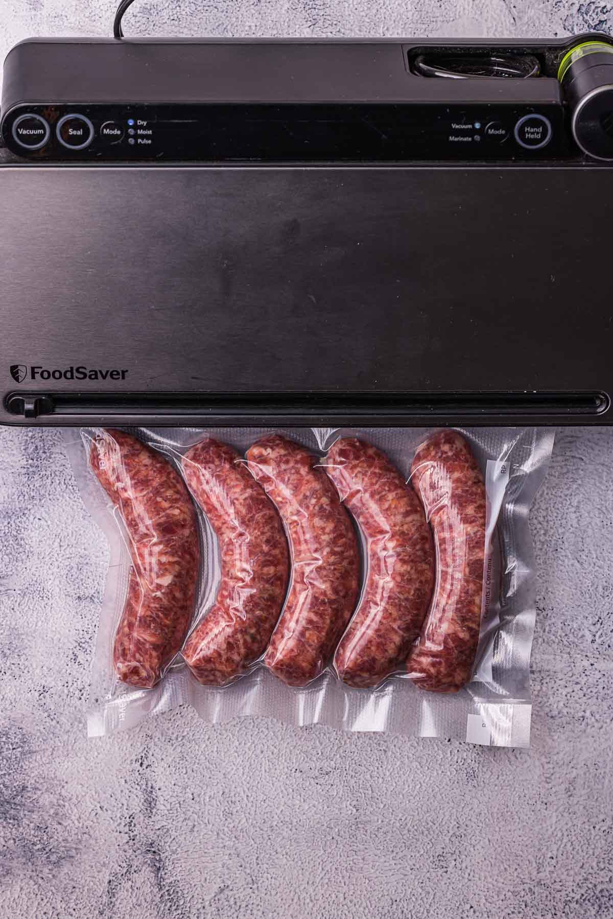 raw sausages being vacuum sealed in a bag