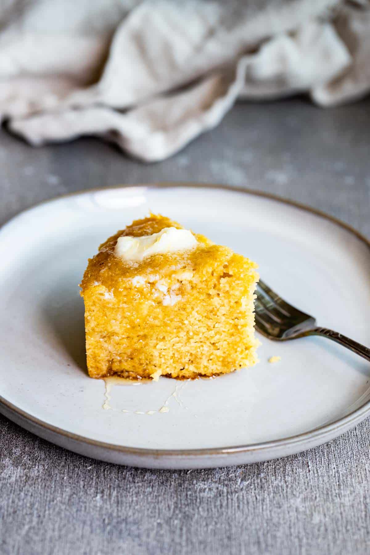 a piece of cornbread on a plate with a fork