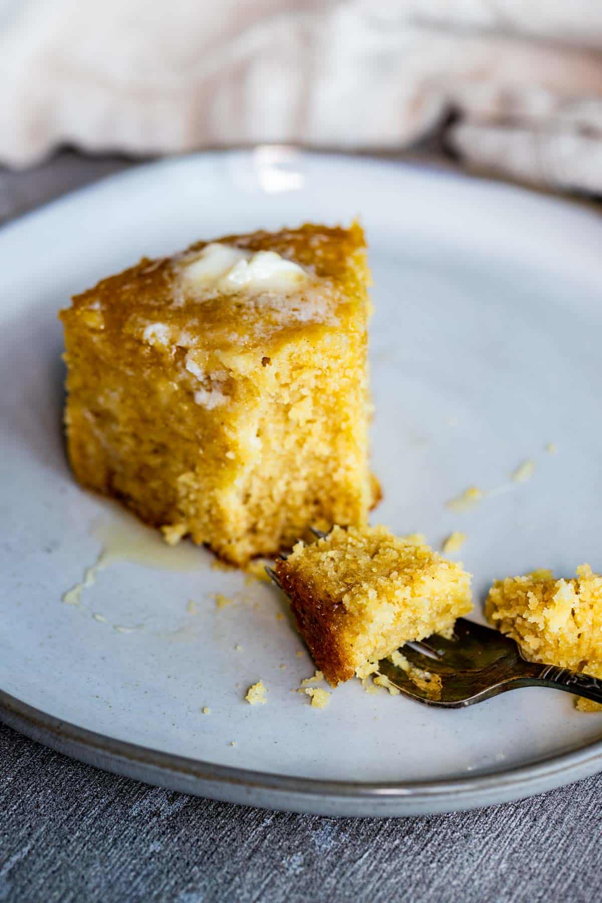 a fork taking a piece of cornbread off