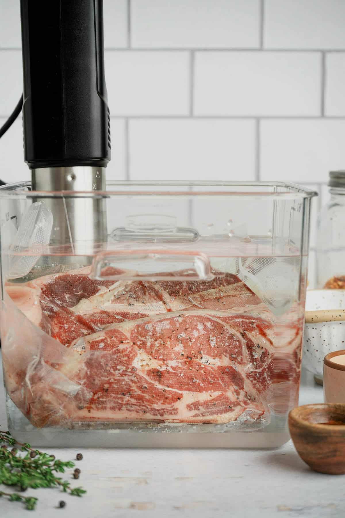 a vacuum seal bag of beef in a sous vide water bath