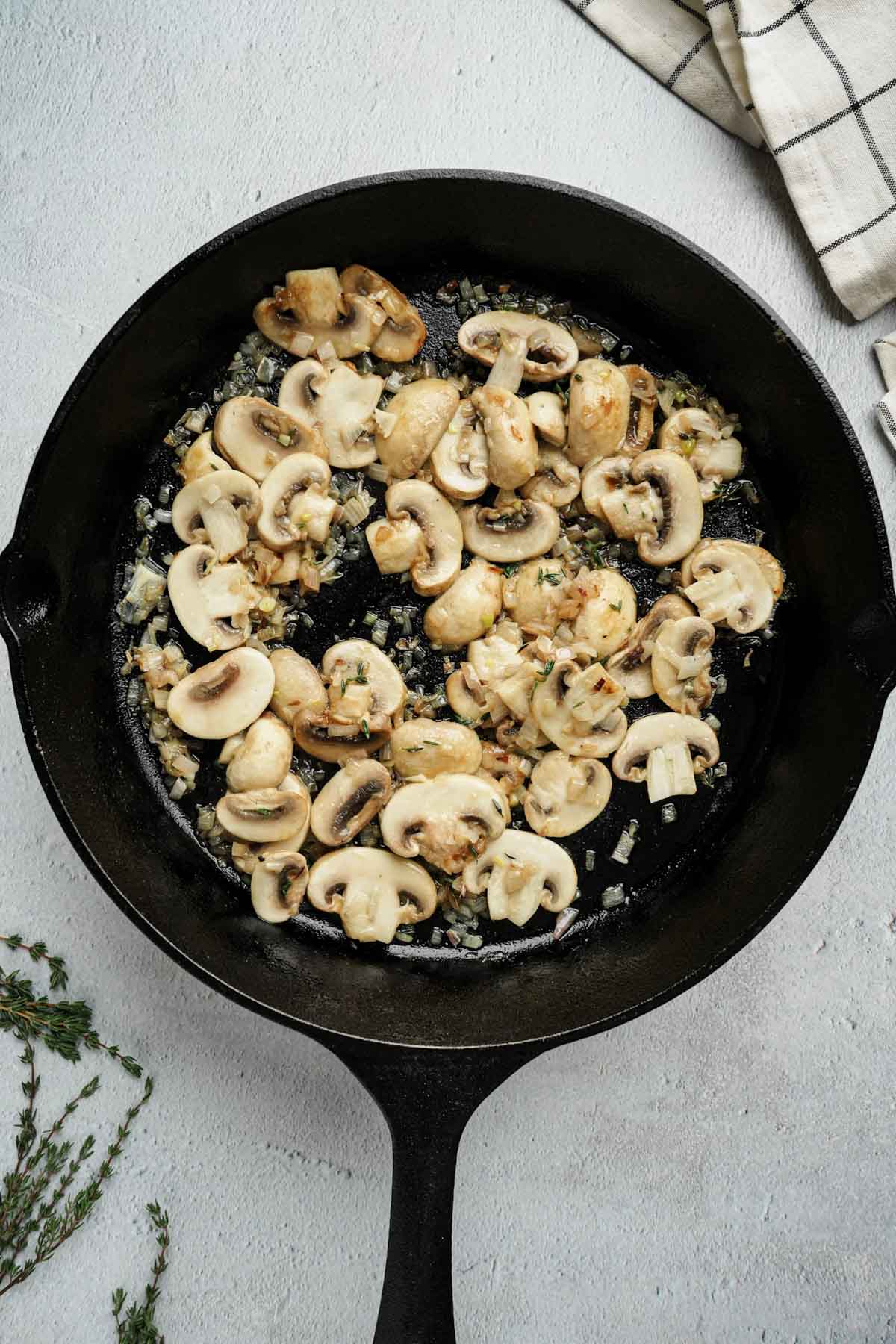 mushrooms being cooked in a skillet