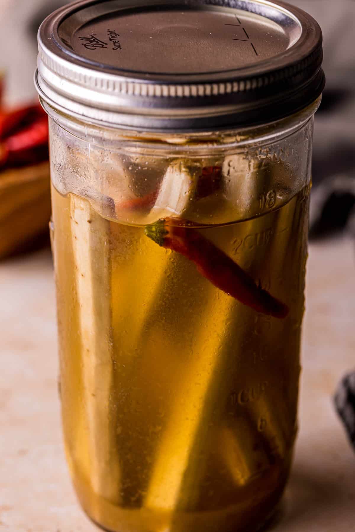 liquid and cut veggies in a jar