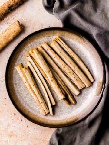 pieces of white peeled burdock root on a plate