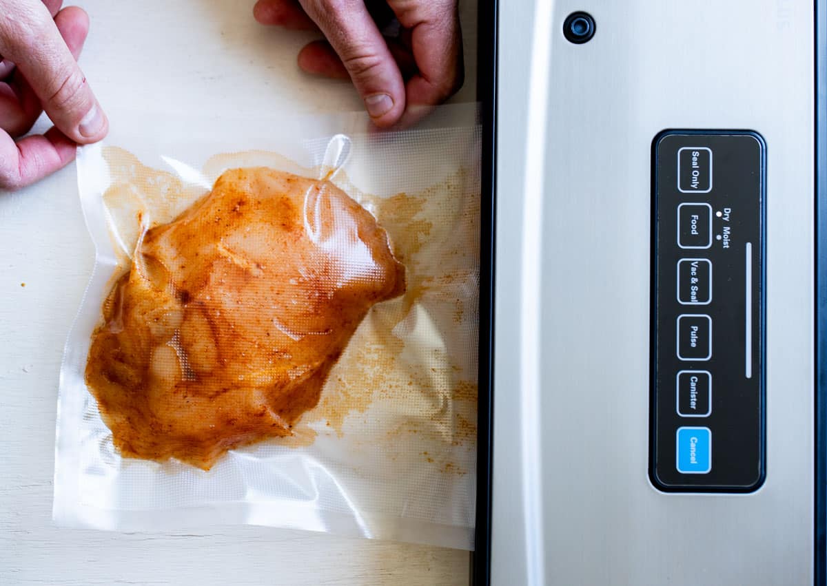 a sealed piece of chicken in a vacuum sealer