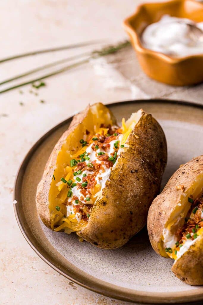 a baked potato stuffed with cheese, chives and bacon