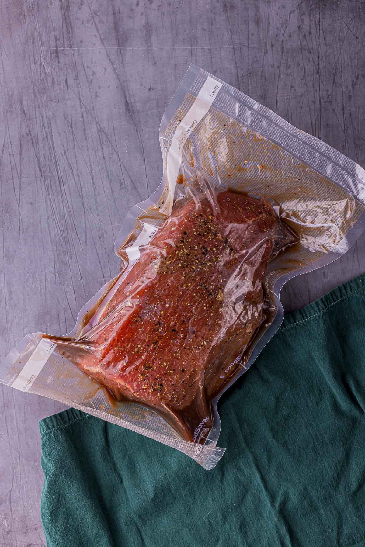 a piece of raw meat in a vacuum seal bag