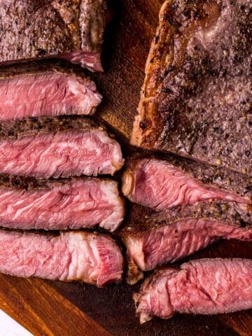 slices of rare steak on a cutting board