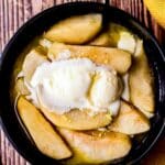 cooked apples slices in a bowl with ice cream on top