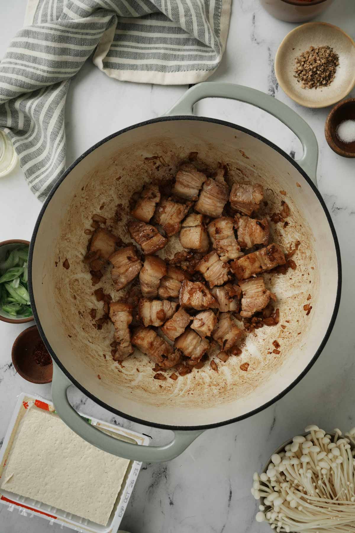 pork belly pieces browning in a pot