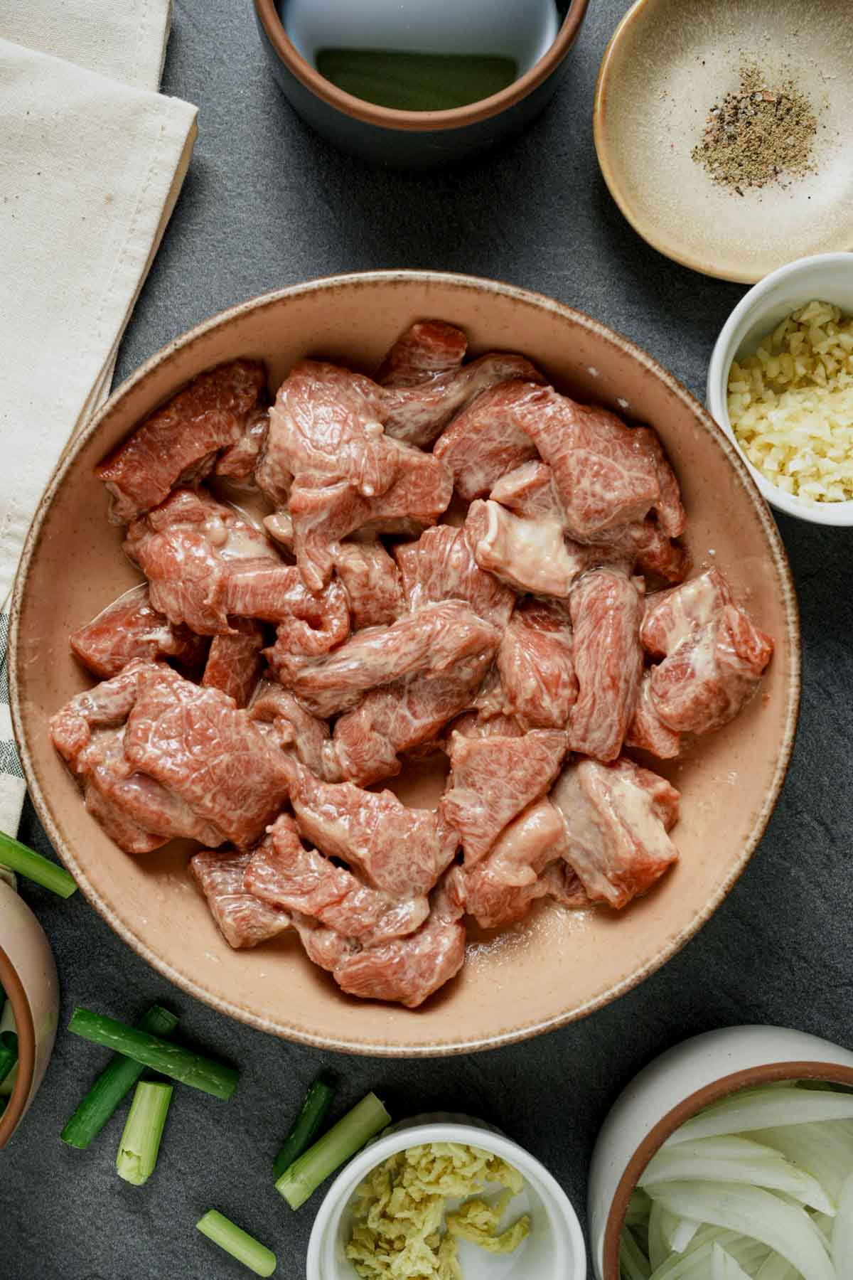 a bowl a seaoned sliced lamb pieces