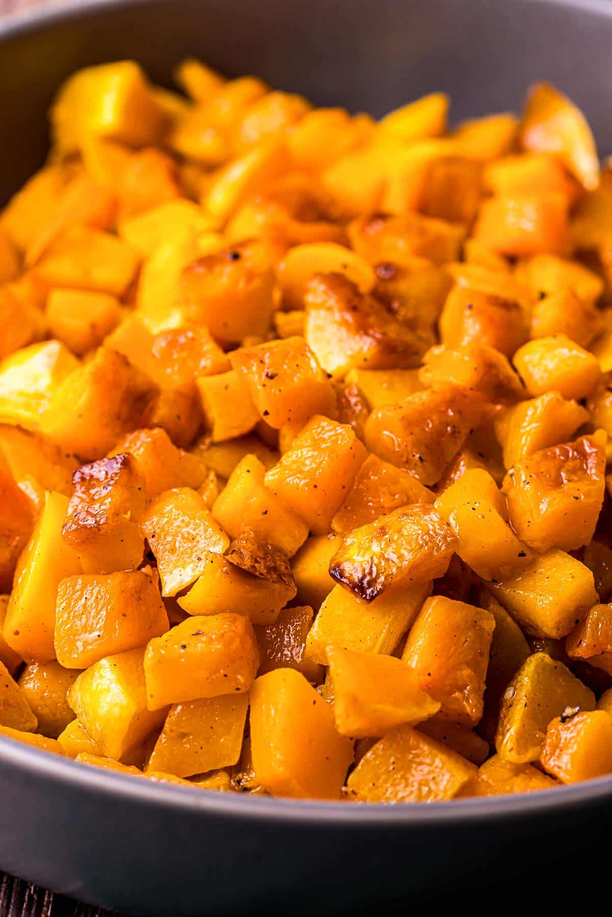 caramelized pieces of butternut squash in a bowl