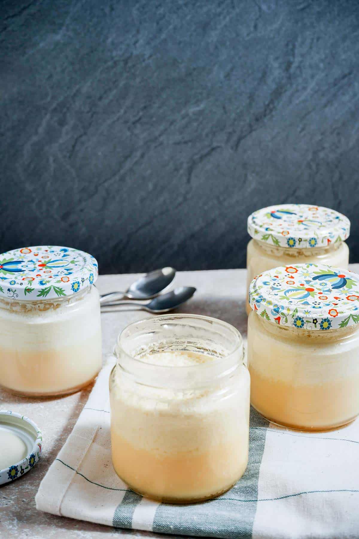 jars of custard on a white surface