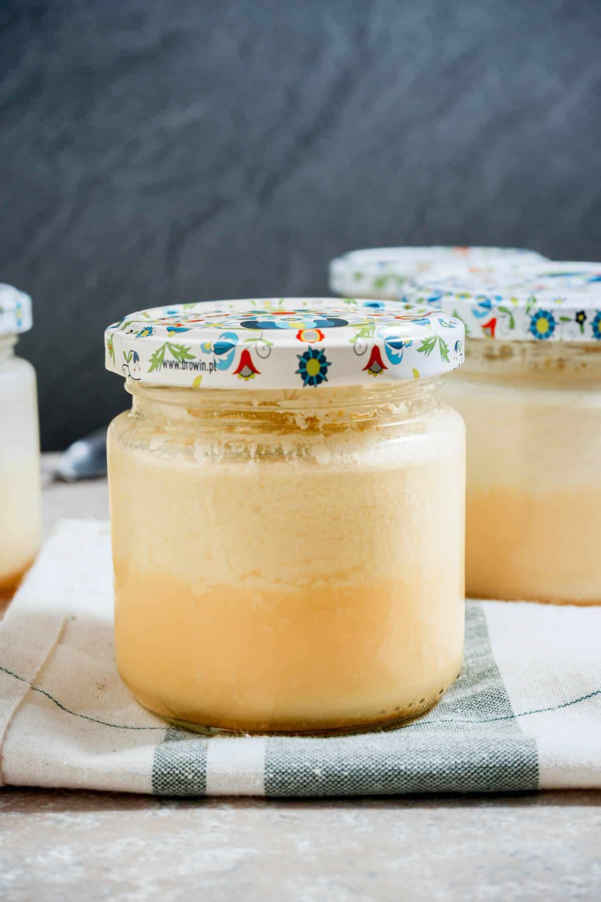 a jar of yellow custard with other jars in the back