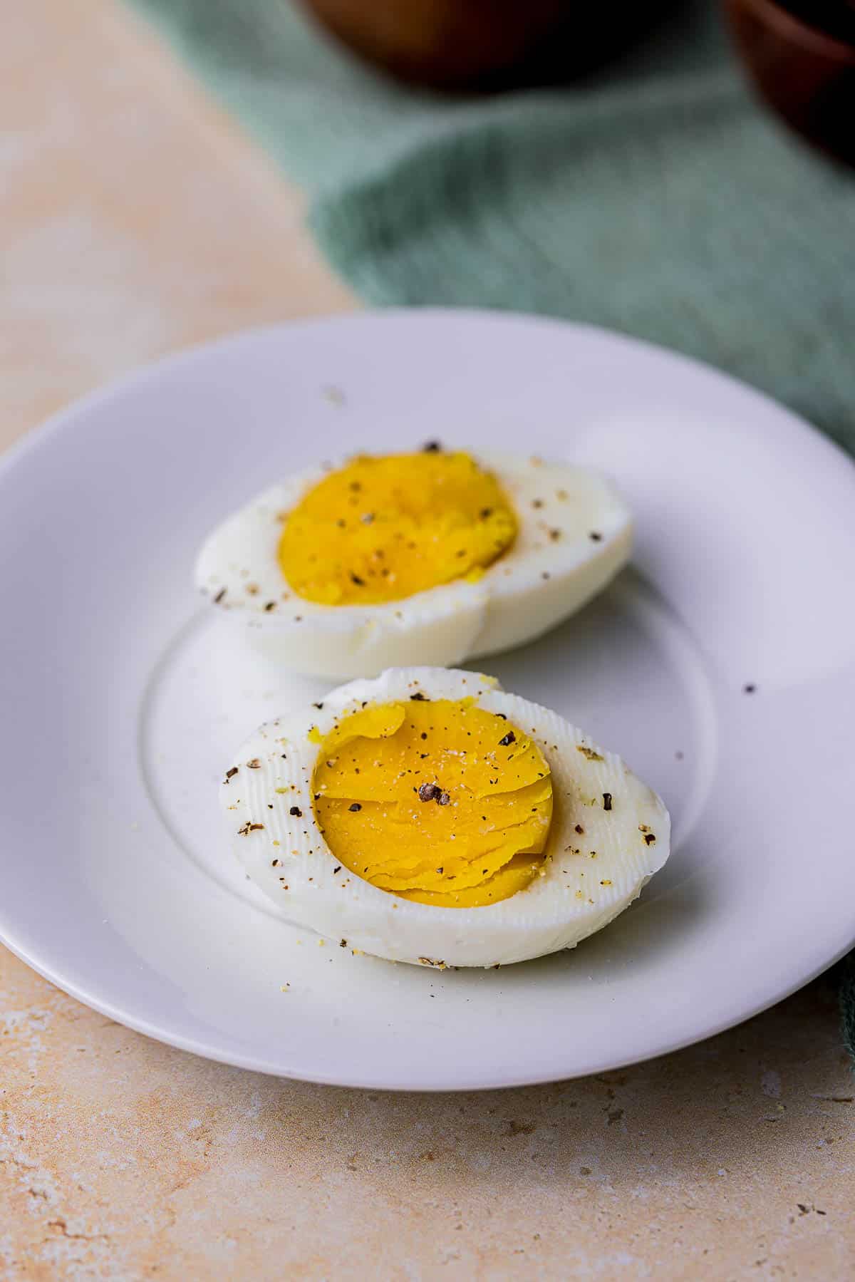 a hard boiled egg cut in half on a plate