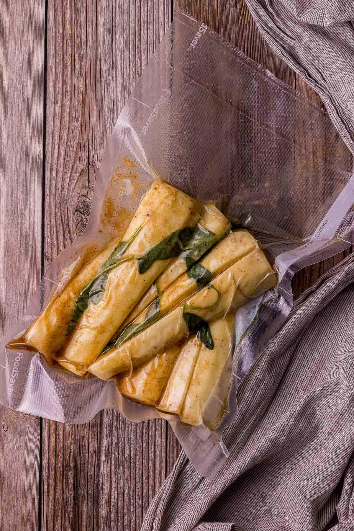 sliced parsnips in a bag with herbs
