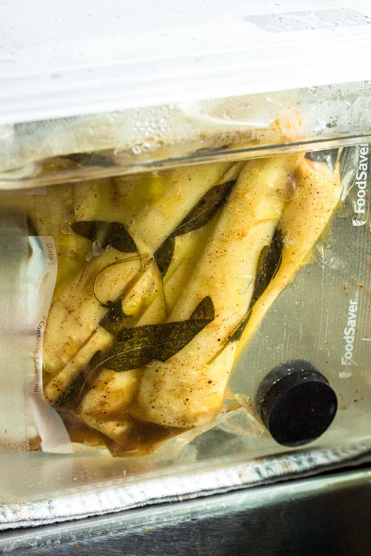 parsnips being cooked in a bag in a water bath