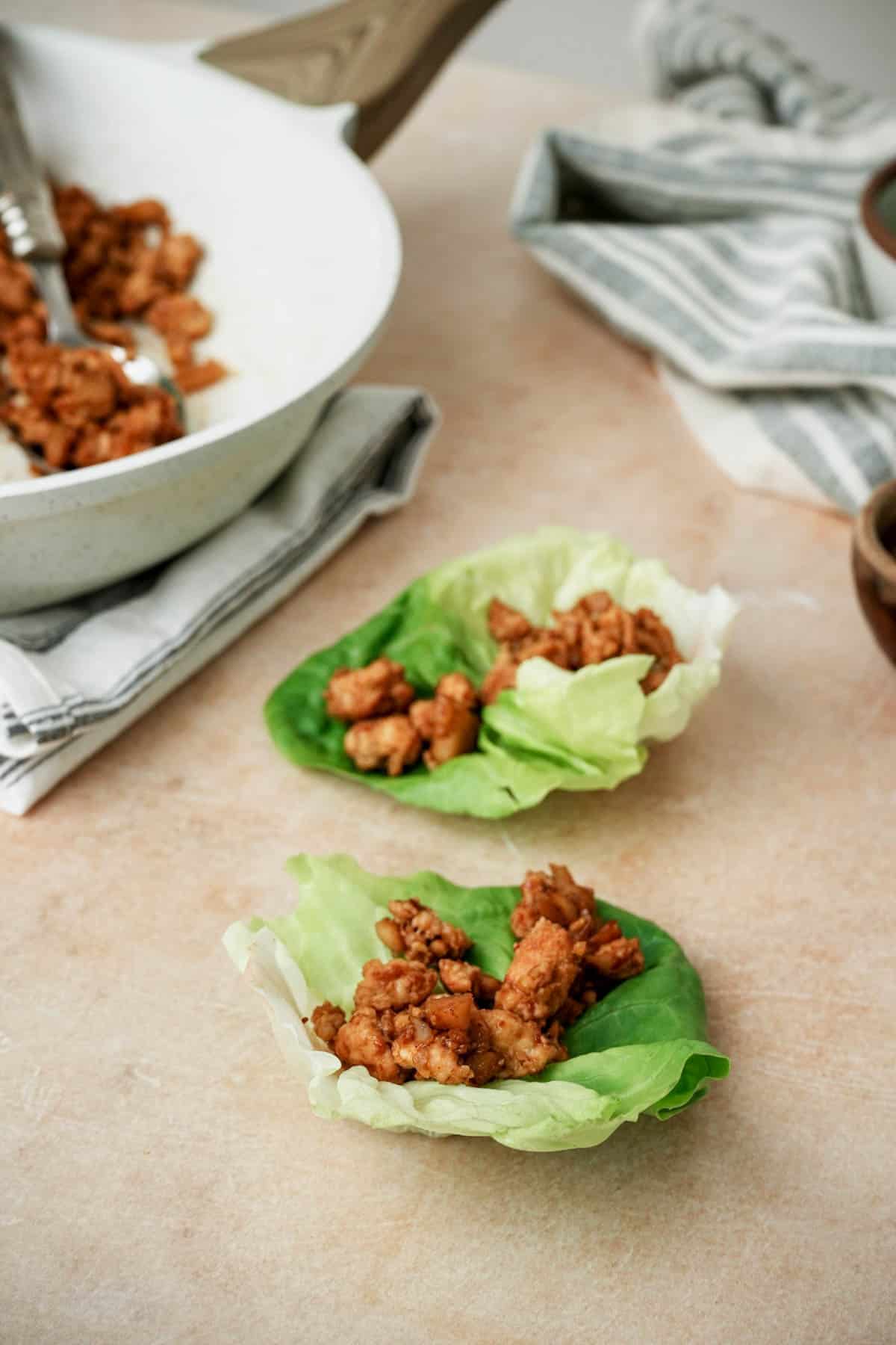 mini lettuce cups holding spiced ground chicken on a board