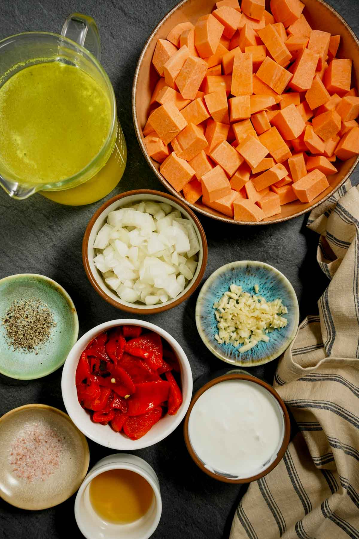 ingredients for soup in small bowls on a board