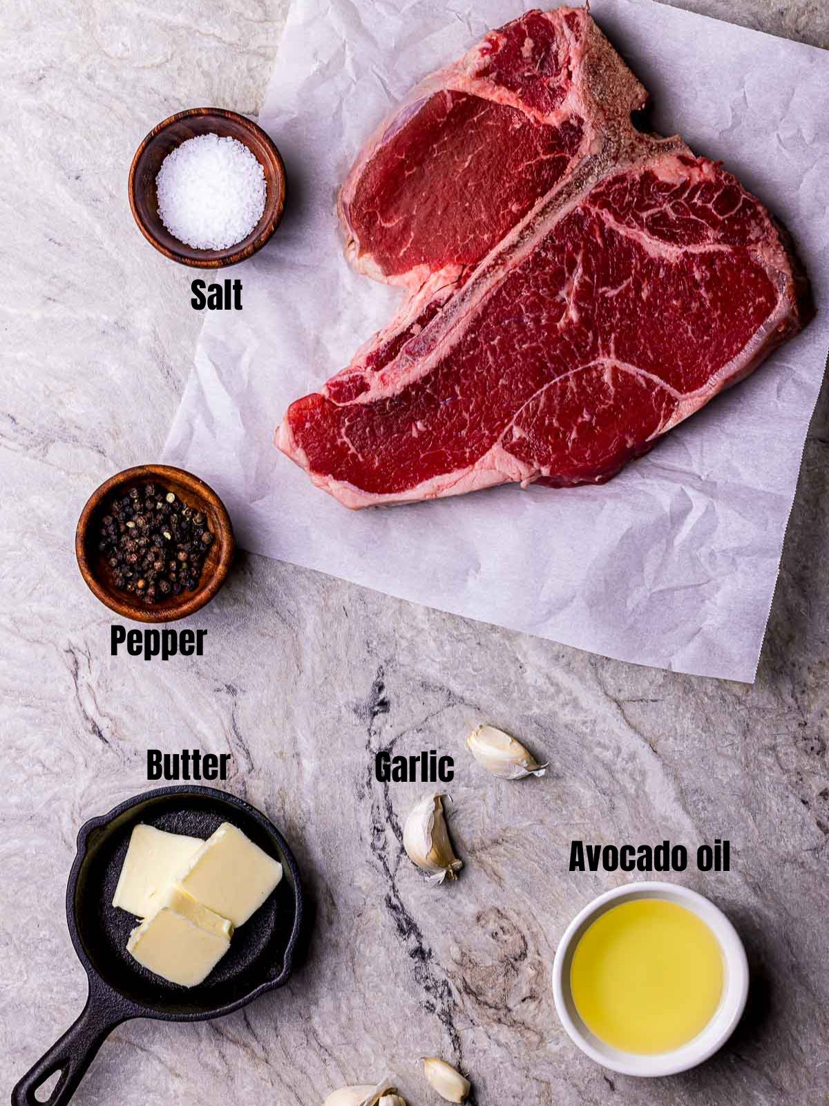 ingredients for sous vide porterhouse on a white table surface