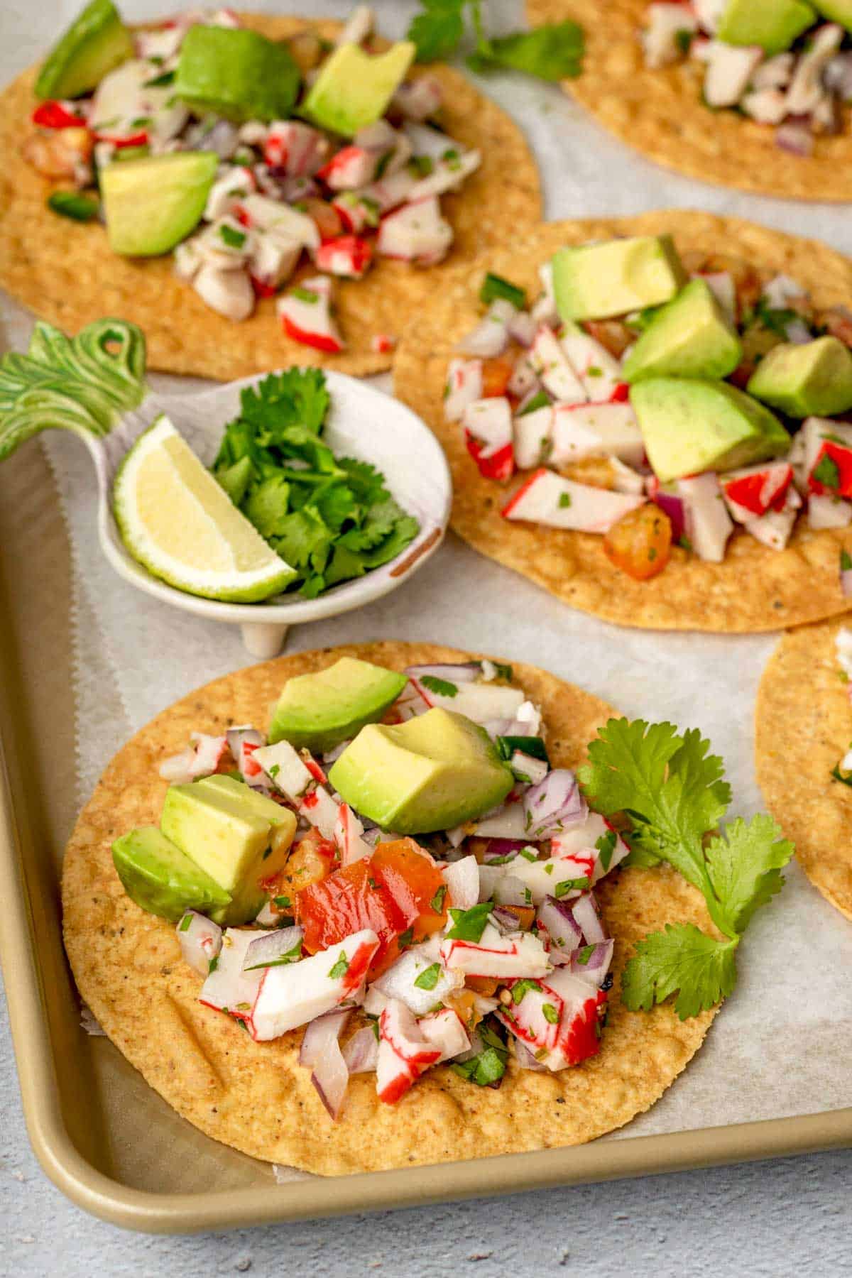 crab ceviche on a tostada shell with avocado and cilantro