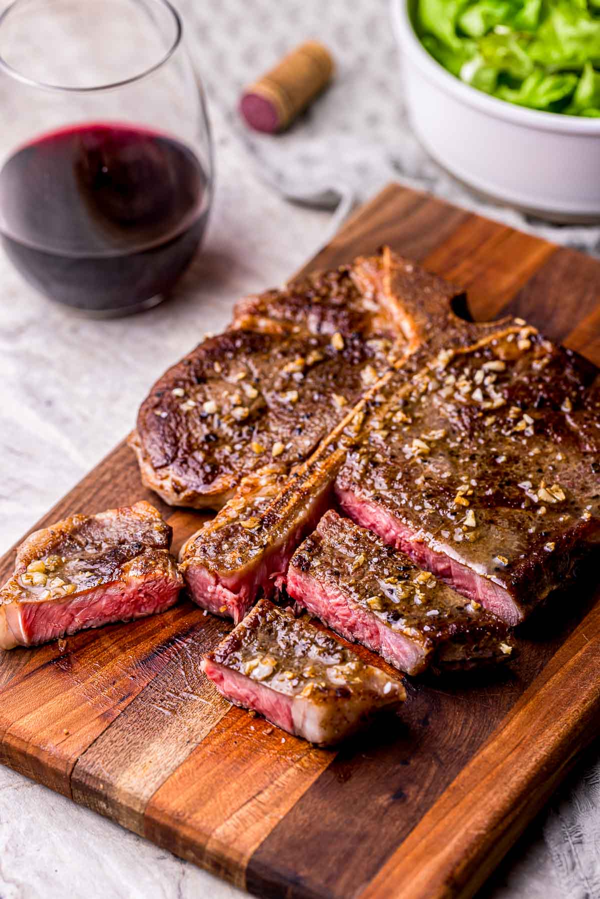 a steak sliced up on a cutting board
