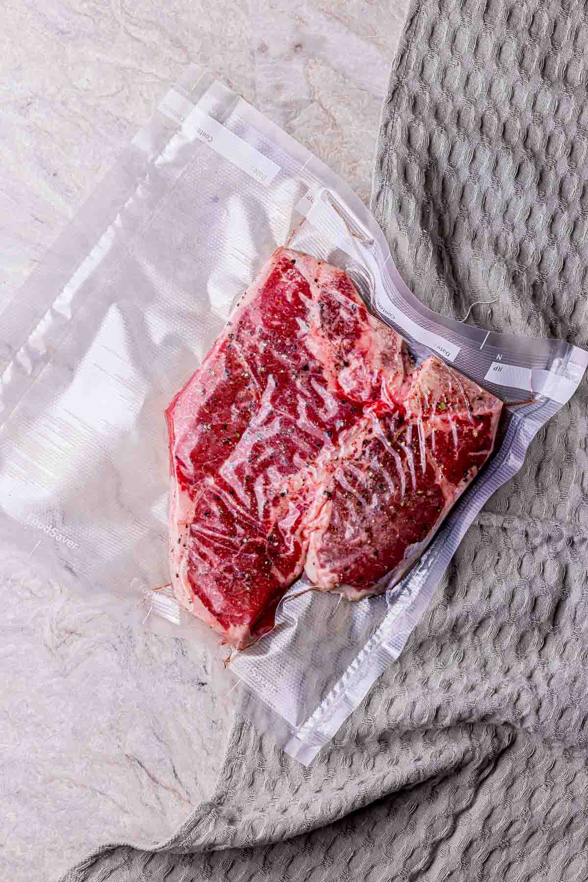 raw steak in a vacuum seal bag