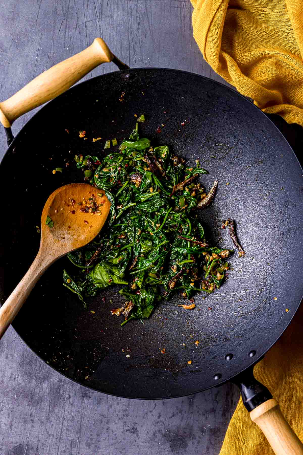 wilted green and spices in a wok