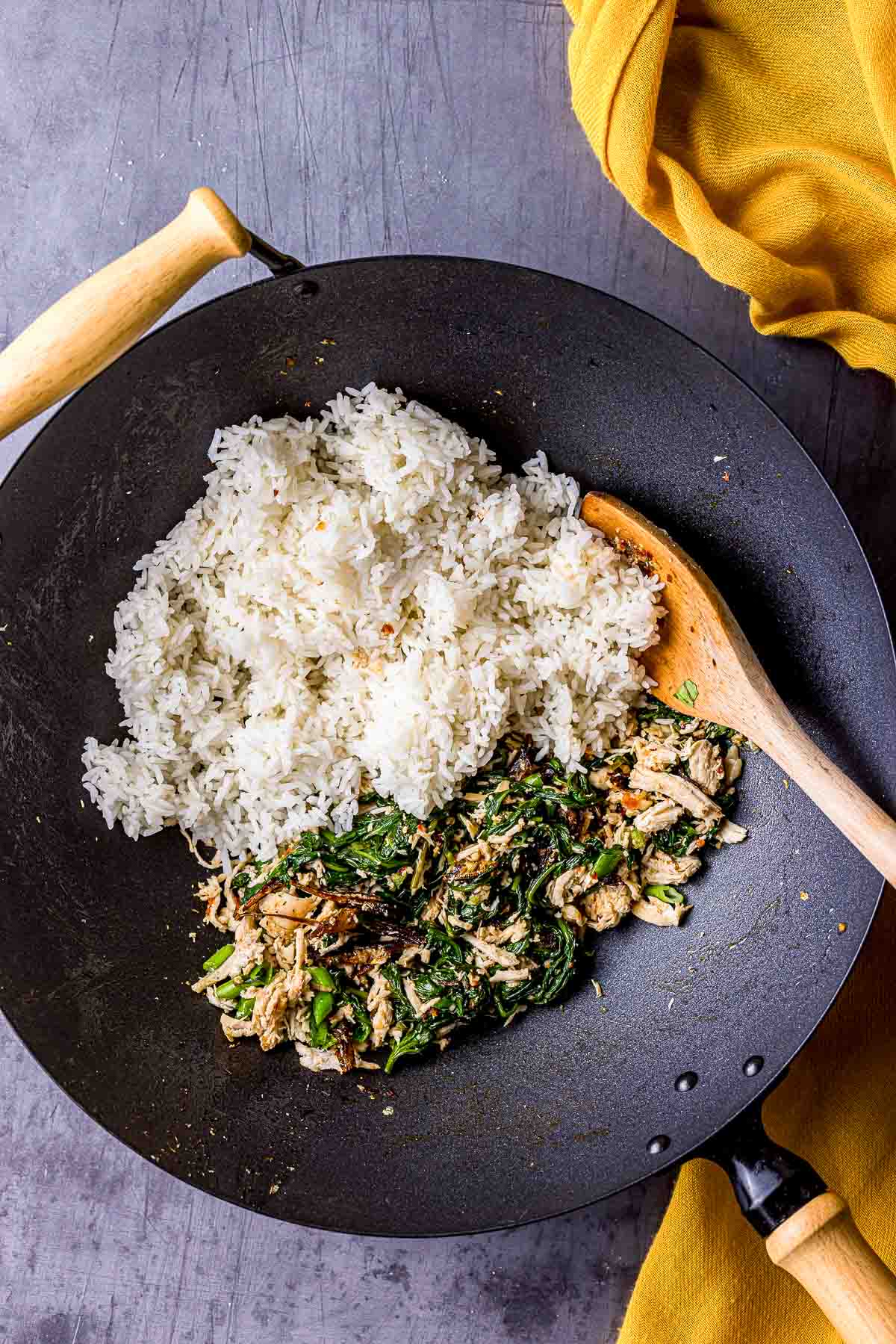 white rice with green mixture in a wok