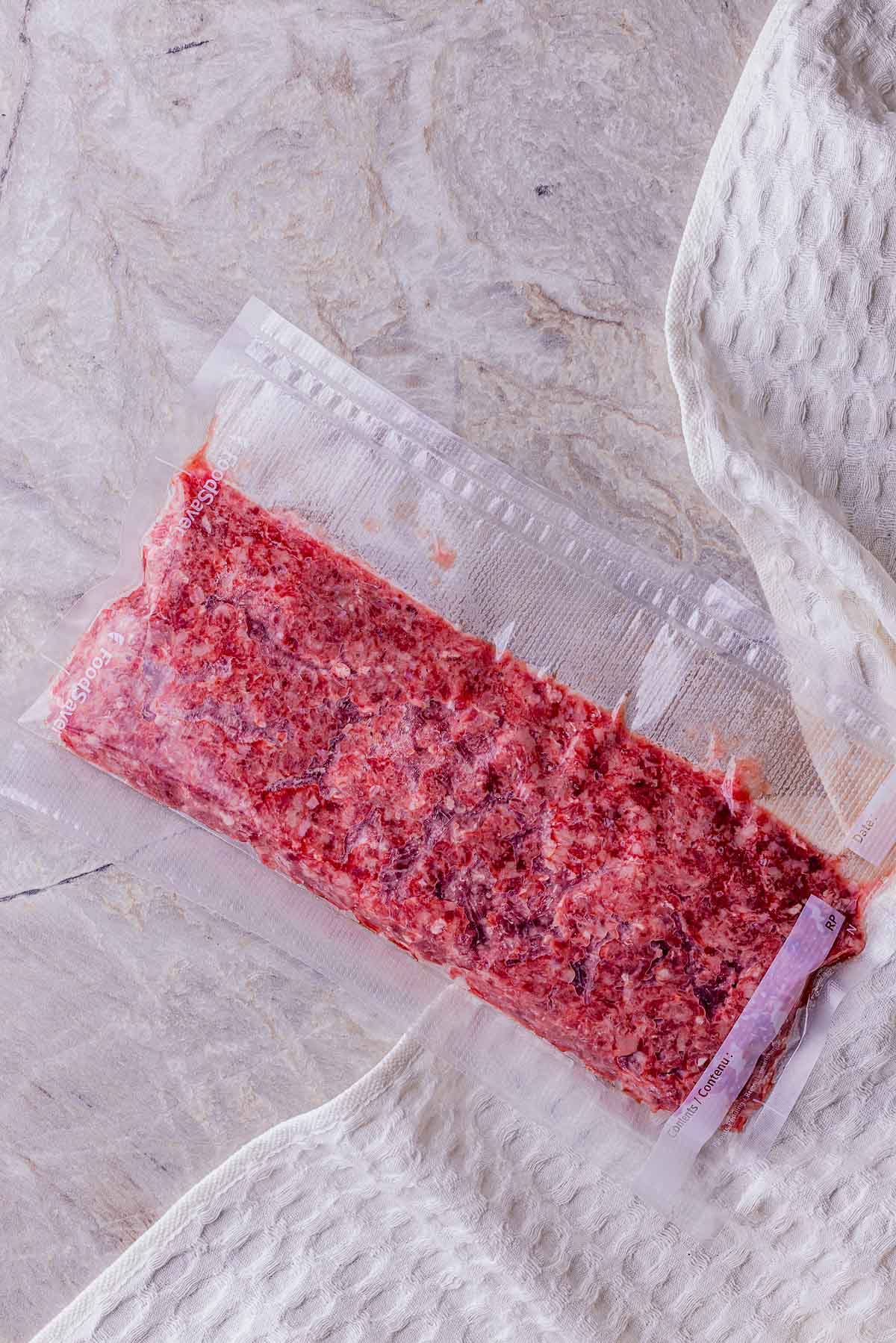 raw ground beef in a vacuum seal bag