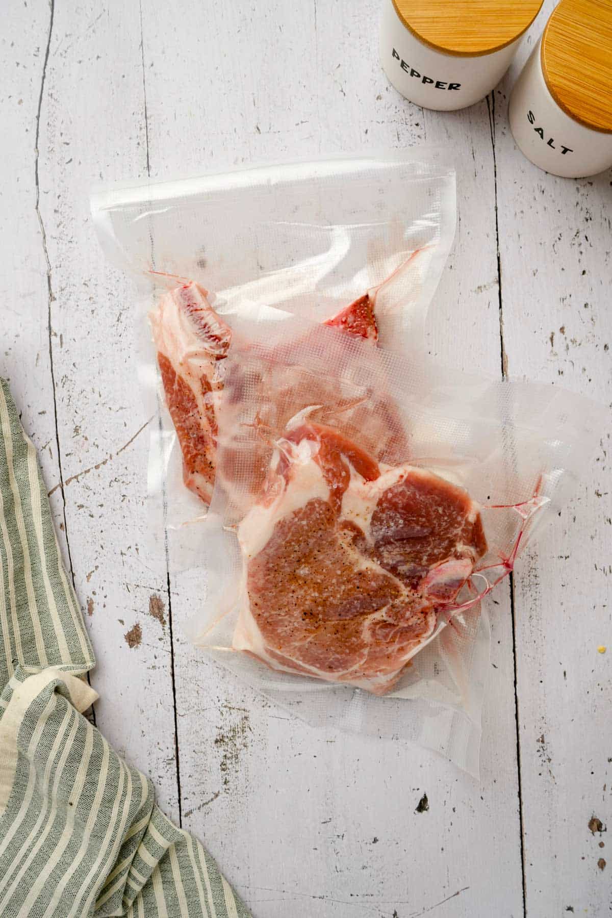 raw pork chops in a vacuum seal bag
