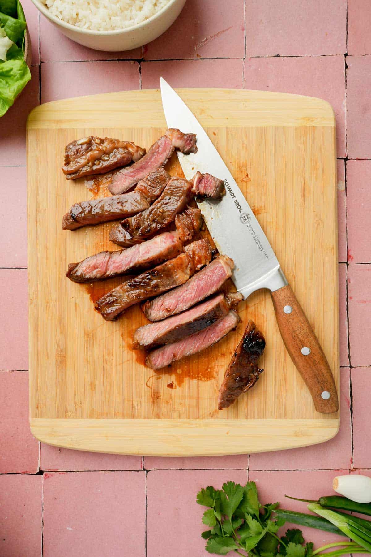 sliced up beef on a wood cutting board