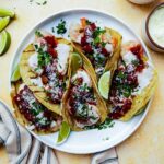 shrimp tacos on a plate with salsa