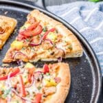 a slice of pizza on a baking sheet.
