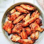 a plate of cooked chicken wings.