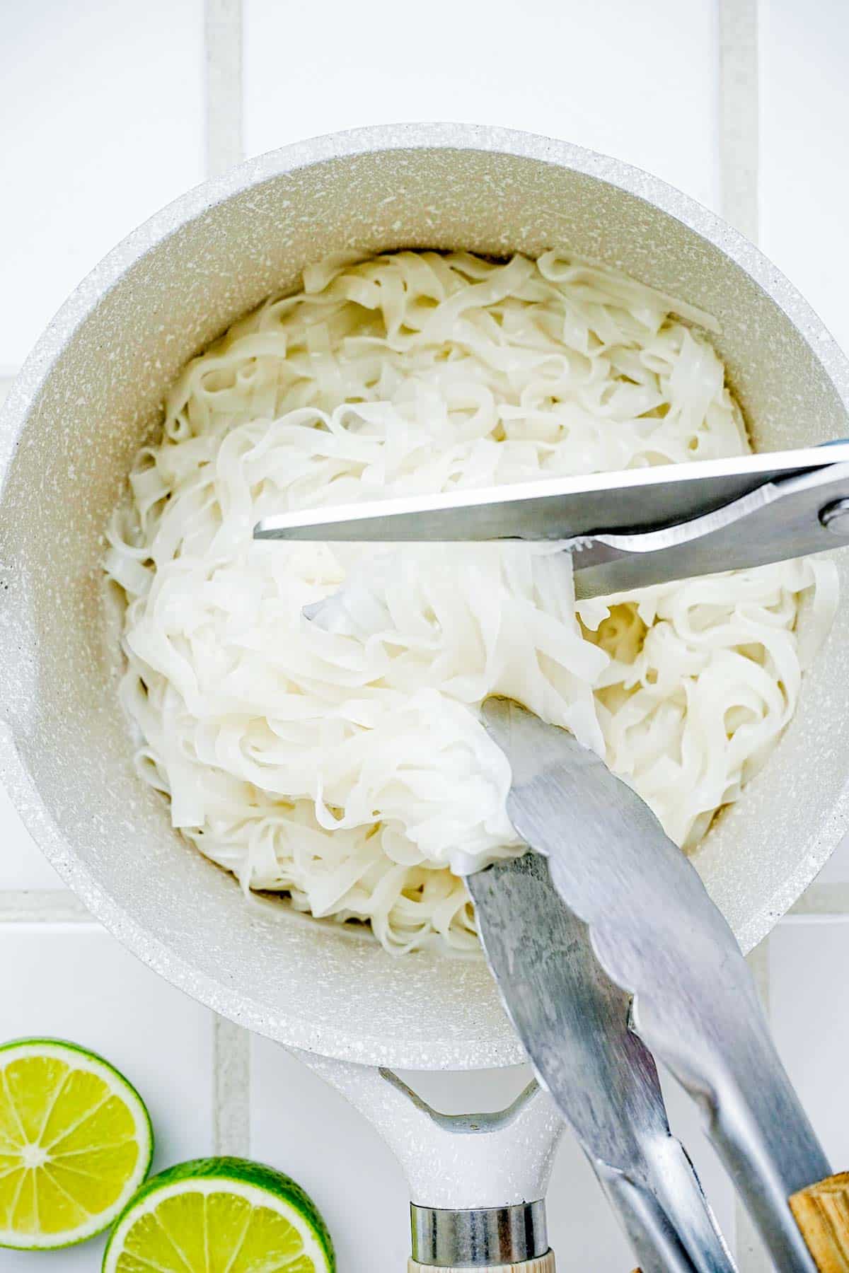 noodles being cut with scissors.