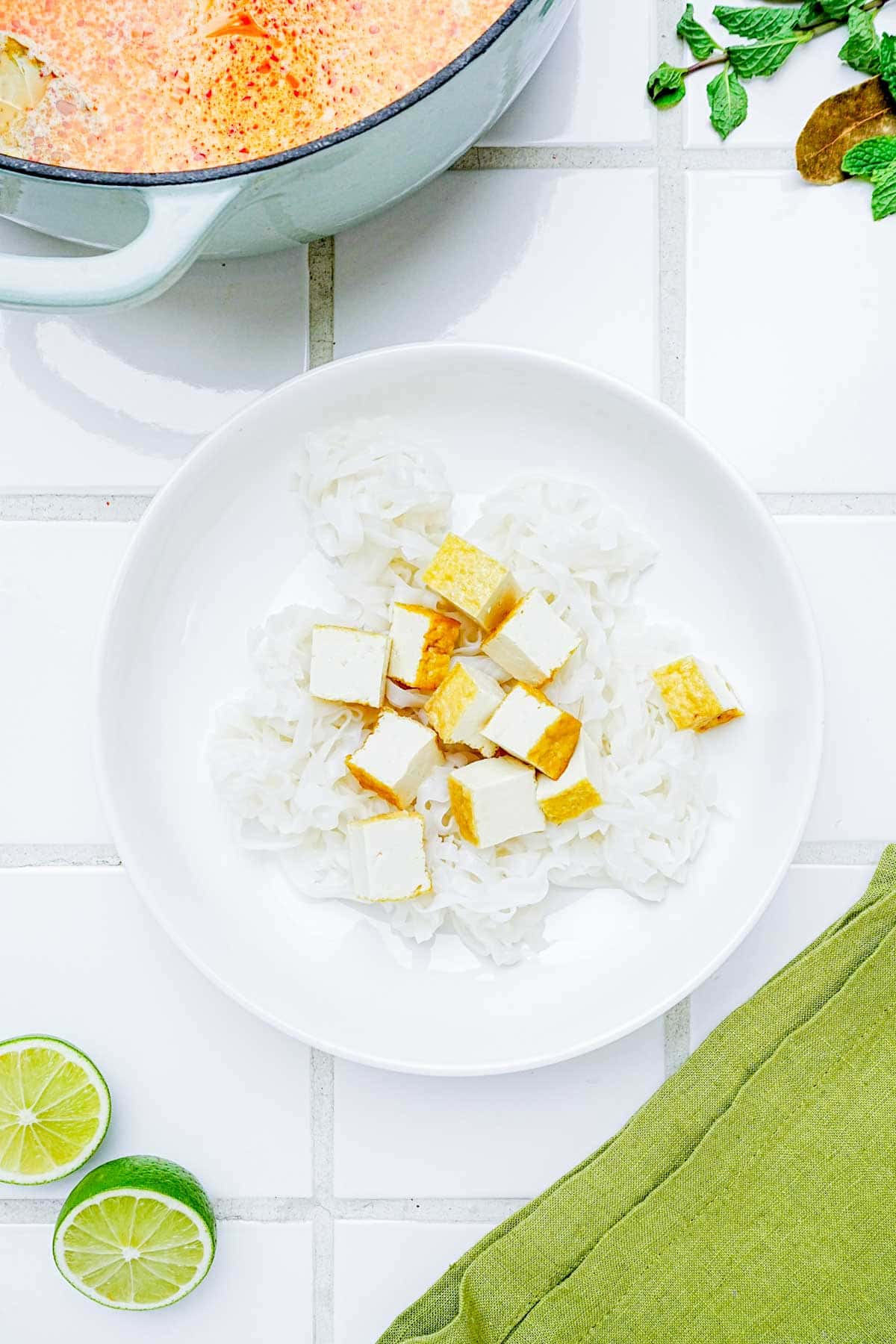 noodles and tofu cubes in a bowl.