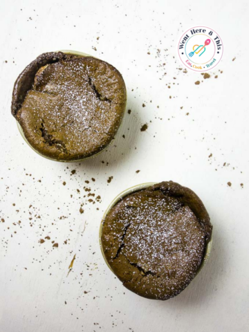 A minimalist overhead shot of an easy chocolate soufflé recipe, showcasing the rich dark chocolate texture and powdered sugar garnish.