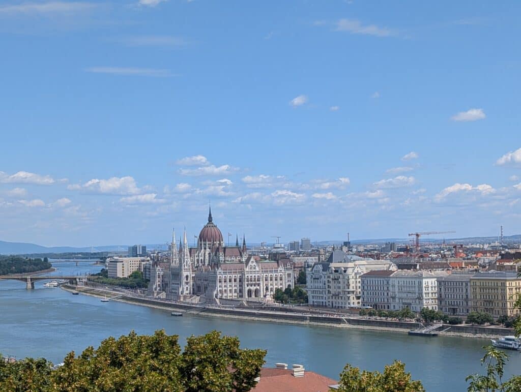 Panoramic view features the Hungarian Parliament Building, a prominent Neo-Gothic landmark located on the Pest side of the Danube River taken from Buda castle