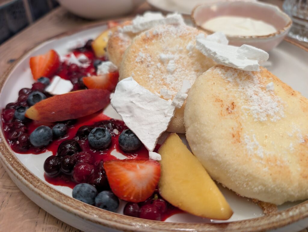 Cottage cheese pancakes The fluffy pancakes were served with sweet cream, seasonal fruit and delicate meringue, creating a combination that was creamy, fruity and just the right amount of indulgent.