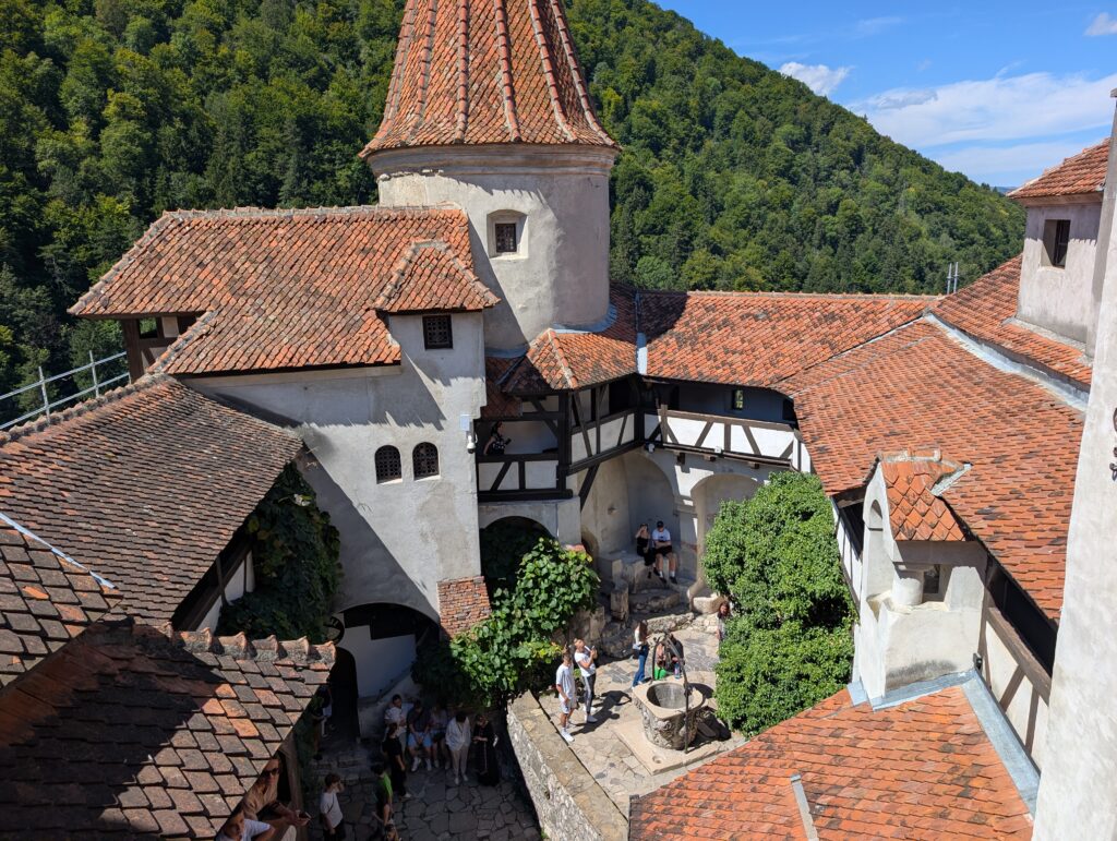 Beautiful views overlooking Bran Castle’s courtyard and the majestic surrounding mountains.