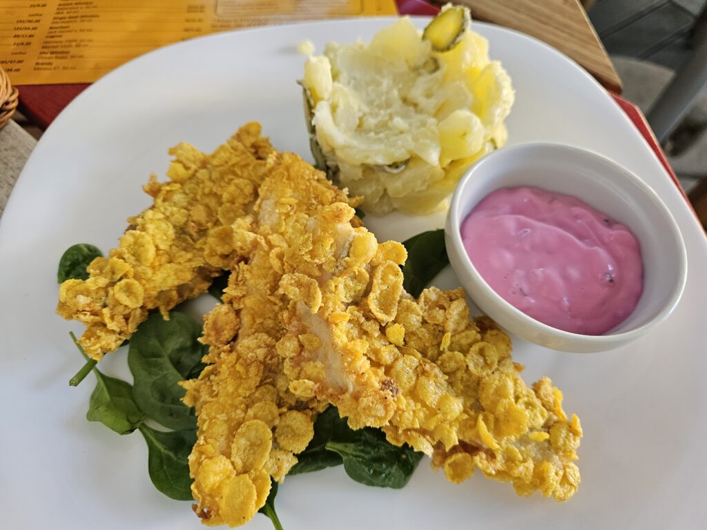 What I Ate in Romania : Zander, a freshwater fish commonly found throughout Central and Eastern Europe. This fish was battered in egg and flour, coated in cornflakes (yes, cornflakes!), and fried until perfectly crispy. The fish itself was light and tender, while the cornflake coating gave it an incredibly crunchy exterior with just a hint of sweet corn flavor.
