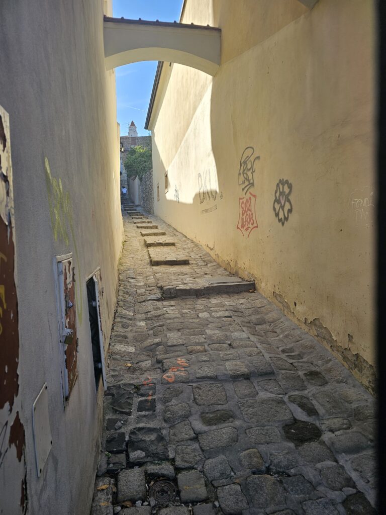 narrow medieval alleyway with stone steps and an archway located in the Old Town of Bratislava, Slovakia